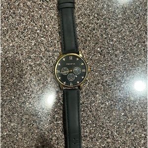 Men’s Gold and black Geneva watch with leather strap.